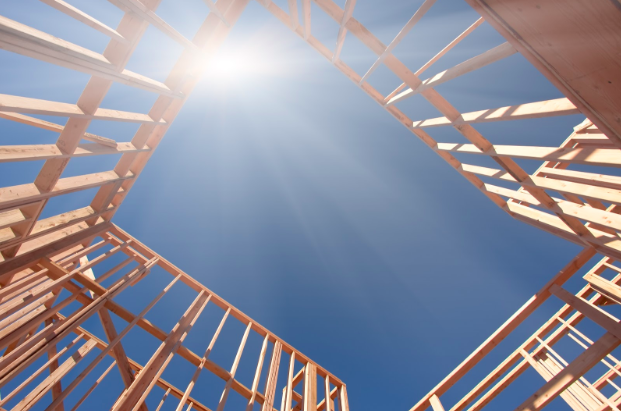 The sun shining through a building frame